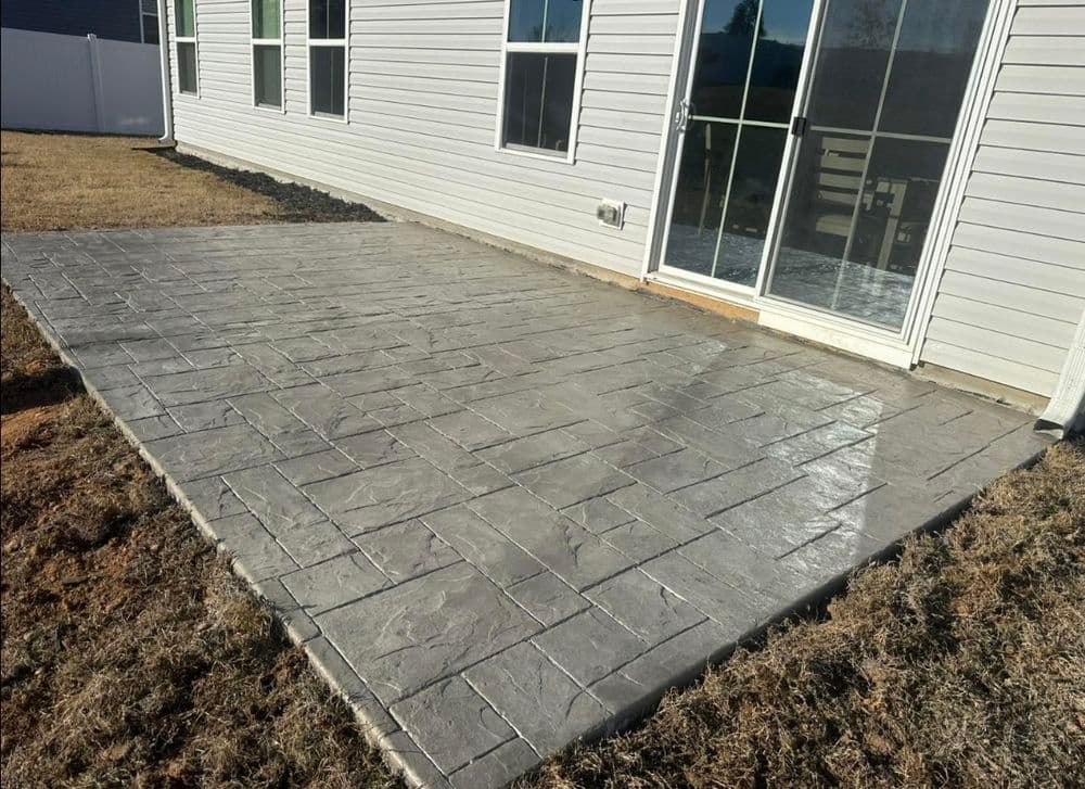 Patio with stamped concrete design, showcasing a modern outdoor living space.